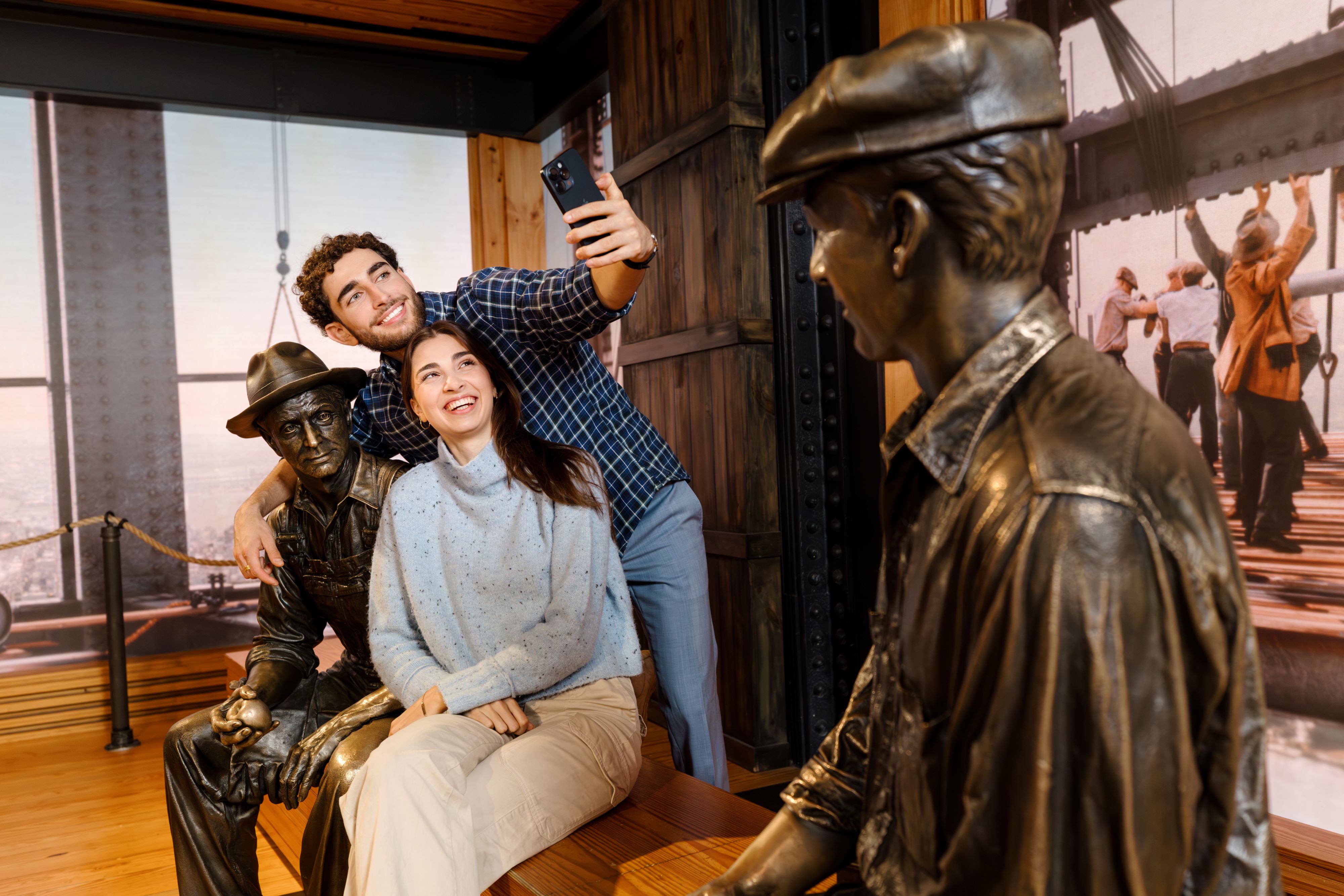 Man and Woman taking a selfie at the constriction exhibit in the Empire State Building Observatory.